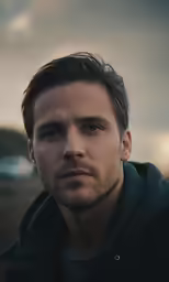 a man is looking to the left with an intense expression