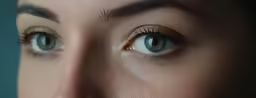 two blue eyes, one with large eyelashes