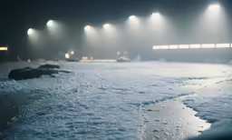 a row of white stadium lights on a snowy field