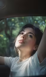 a girl is sitting in the car waiting for something