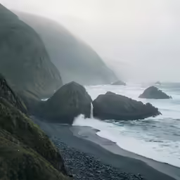 an area with rock formations, water, and sea