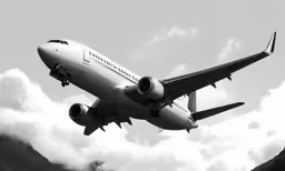 an airplane flying in the sky over mountains