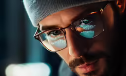 the man is wearing a pair of glasses with snow on them