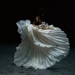a women who is wearing a white dress
