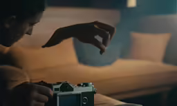 someone pointing towards the camera in a dark room