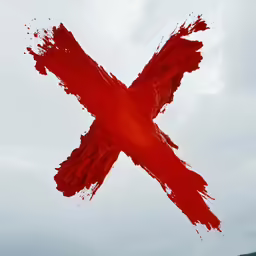 red ink on a grey background being spread across the picture