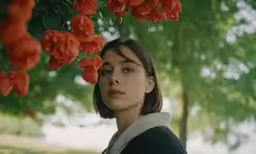 an image of a girl in front of flowers