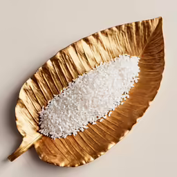 the rice is on a golden leaf as if it were rice