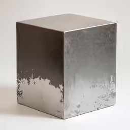 a metal cube is shown with silver paint on it