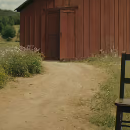 a rustic farm scene with a rustic barn and a bench