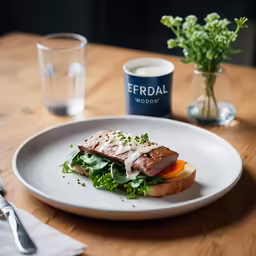 a meal on a plate near a water glass
