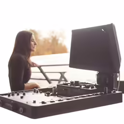 a woman is standing in front of a turntable