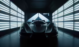 a white sports car is sitting in a dark room