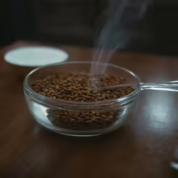 a glass bowl full of dog food with steam rising out of the inside