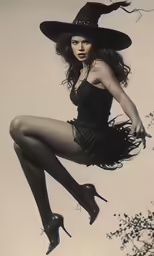 a young woman with an witch costume, posing for the camera