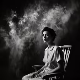 a woman sitting in a chair looking at the sky