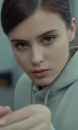 the young woman is looking into the camera