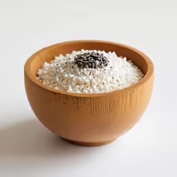 a wooden bowl with a white and brown rice topping inside