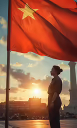 a woman looking up at the sky, next to a flag