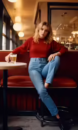 a woman sitting on top of a red bench