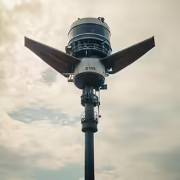 a huge building with an airplane at the top