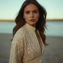 a girl wearing white posing on a beach