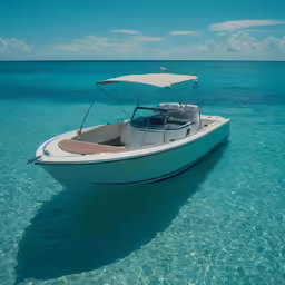 small boat moored in shallow blue ocean waters