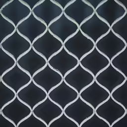 the white wire mesh is hanging from the wall