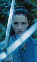 a young woman is holding a large sword