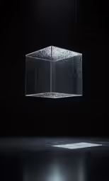 an illuminated cube hanging from the ceiling in a dark room