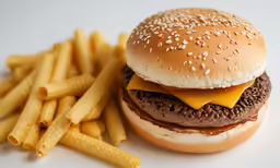 cheeseburger on a whole wheat bun next to fries