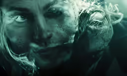 a woman with wet hair is holding a cell phone