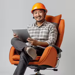 an image of a man on a chair that is holding a tablet,the man is sitting on an orange office chair