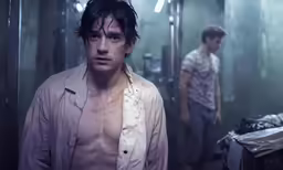 two men in a hallway staring off to the side