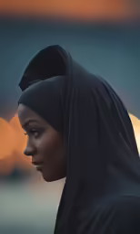 a woman wearing black veil looking away from the camera