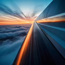 the wing of an airplane as it looks out over the clouds