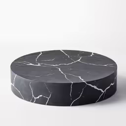 a white marble round coffee table on white