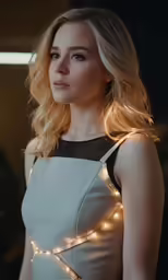 a blonde woman wearing white and black dress