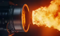 an orange and yellow object on fire with smoke from it
