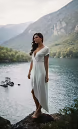 a beautiful woman standing on top of a mountain
