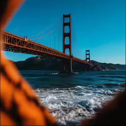 the golden gate bridge across the ocean with waves