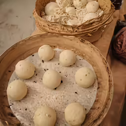 a basket full of raw looking round balls of dough