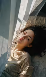 woman lying on a bed and looking away from camera