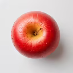 an apple that is half covered in rain drops