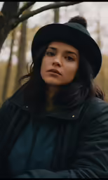 woman wearing hat in the middle of the woods