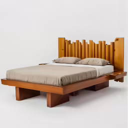 the wood bed has wooden slats as its headboard