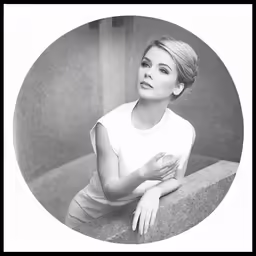 a young woman is leaning against a wall