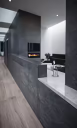 a room with concrete counter tops and dark walls