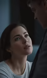 a man staring at the head of a young lady