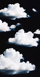 the white clouds are blowing in to the black sky